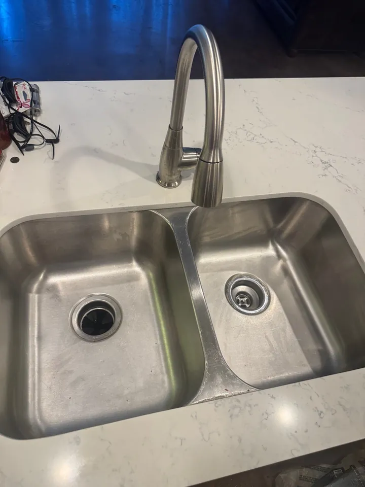 The same stainless sink scrubbed clean after deep cleaning